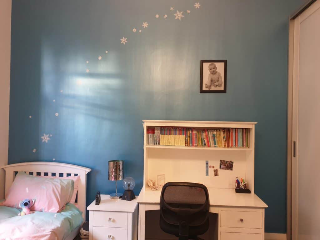 Old bedroom photo - dark blue wall with Frozen themed icicle wall stickers