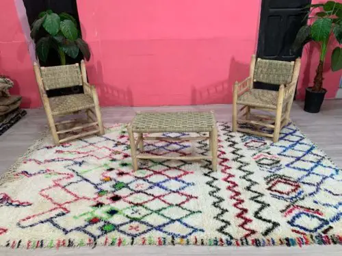 Amira Geometric Rug on floor with chairs and table on top