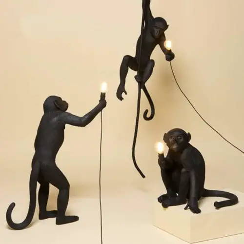 Monkey Lamps three, one sitting, one standing, one hanging in black