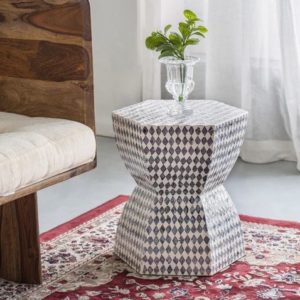Handmade monochrome shell side table or stool in a living room