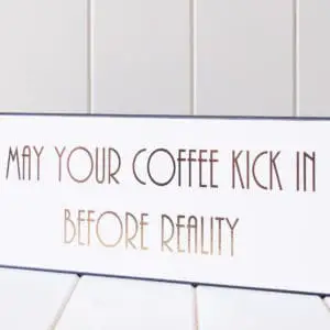 May your coffee kick in before reality sign side view