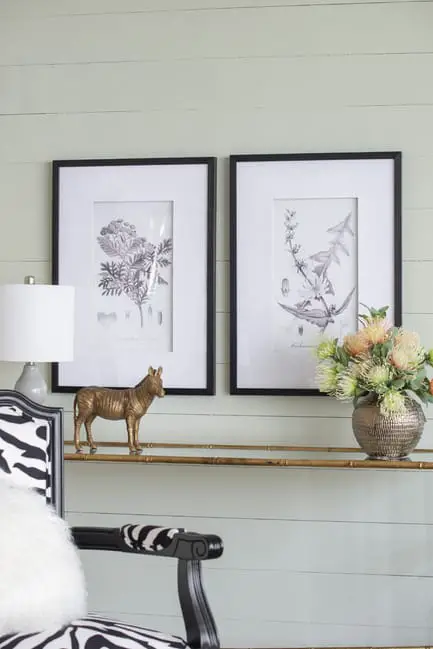 Set of Flora and Fauna Framed prints above a console table