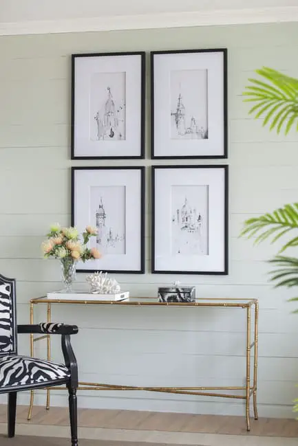 Set of 4 Steeple building prints on wall above console table
