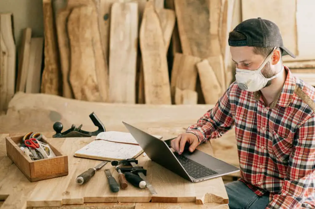 Photo of a man with his tools to create handmade timber products