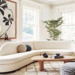 Curved sofas are a big trend for 2022. Curved white sofa in living room