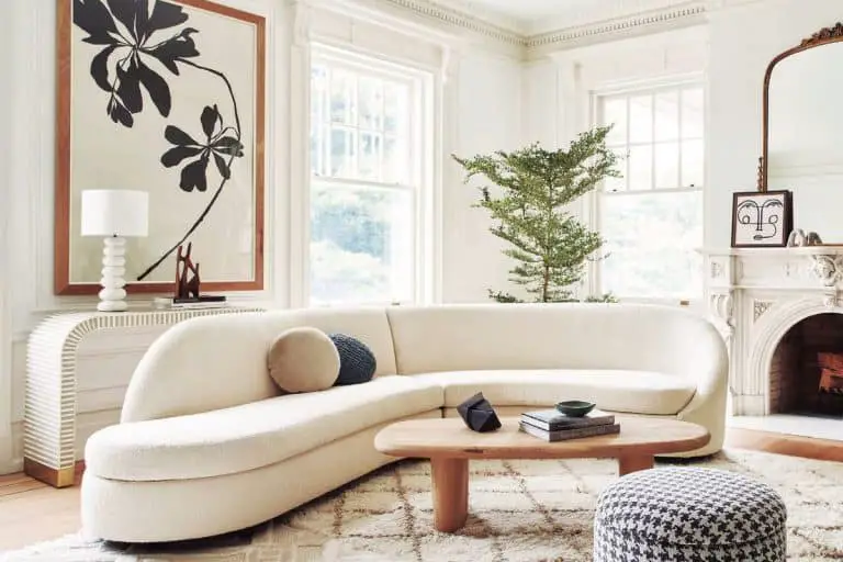Curved sofas are a big trend for 2022. Curved white sofa in living room