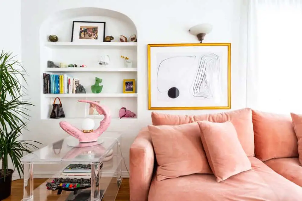 Curved bookshelf, pastel pink sofa